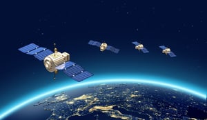 Illustrated artwork of four satellites orbiting above Earth